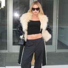 Woman in a faux-fur coat and low-rise pants