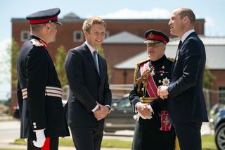 The Duke of Westminster speaking with Prince William outside with two men in military uniforms