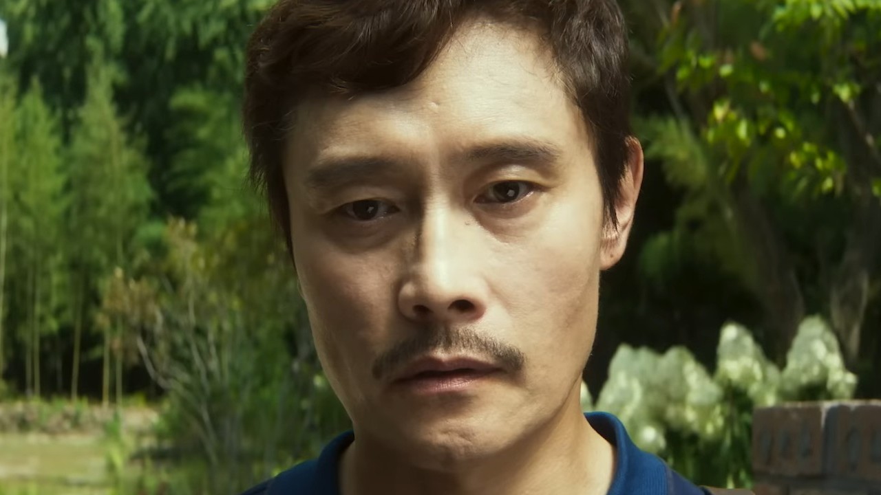Lee Byung-hun looking in the distance in No Other Choice.