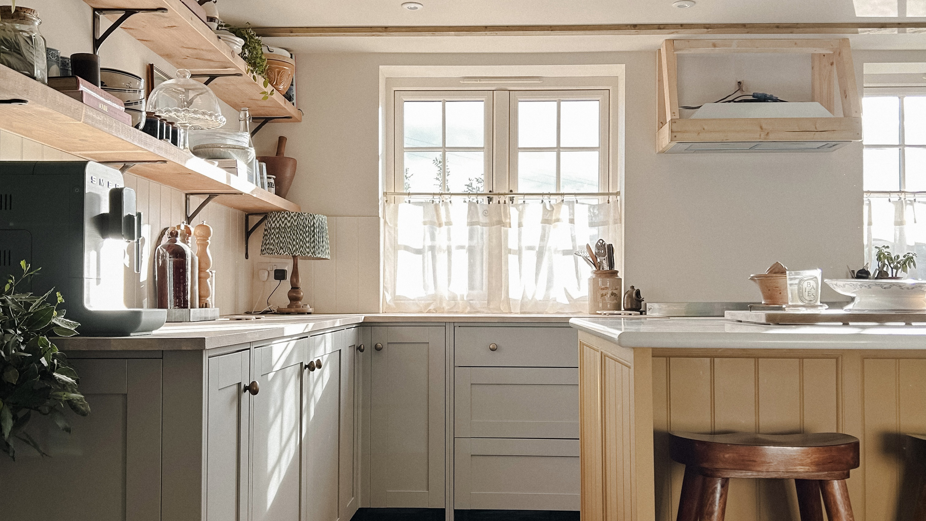 rustic kitchen with yellow island and grey cabinets