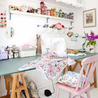 white sewing room with table and sewing accessories