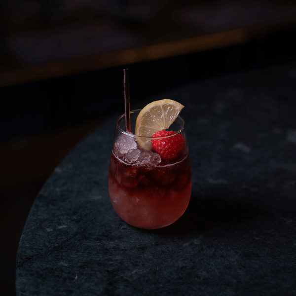 A tumbler with a Port &amp; Bramble cocktail