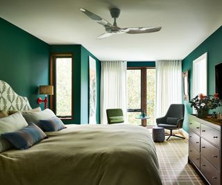 bedroom with dark green walls, white ceiling, calming decor