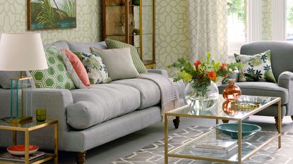 Living room with green trellis wallpaper and grey sofa