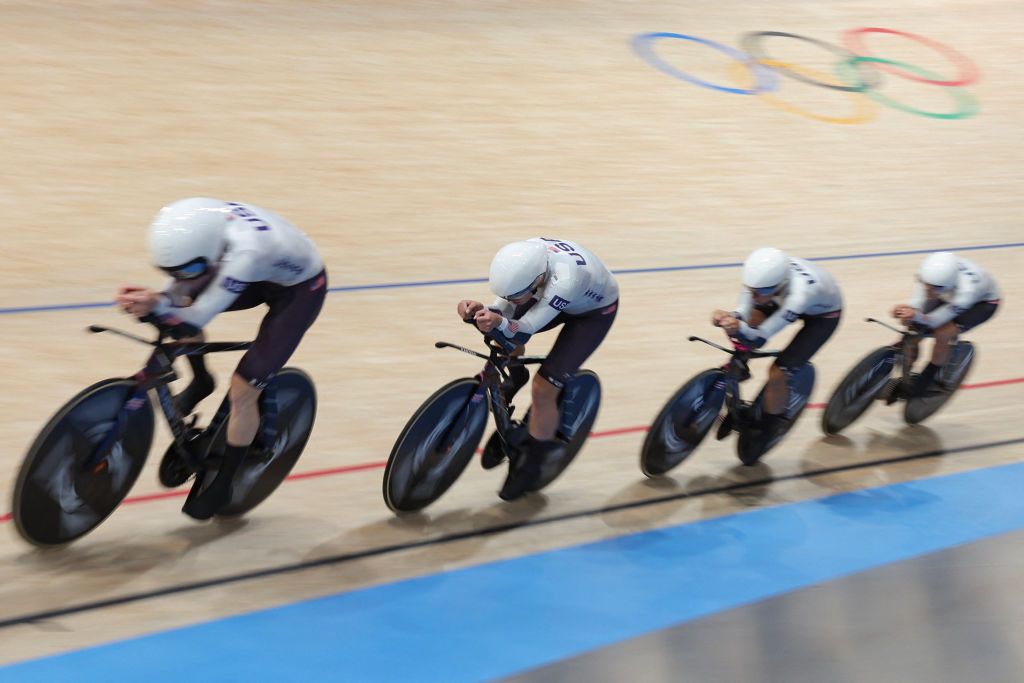 US' Jennifer Valente, US' Lily Williams, US' Chloe Dygert, US' Kristen Faulkner compete in a women's track cycling team pursuit qualifying round of the Paris 2024 Olympic Games at the Saint-Quentin-en-Yvelines National Velodrome in Montigny-le-Bretonneux, south-west of Paris, on August 6, 2024. (Photo by Thomas SAMSON / AFP)