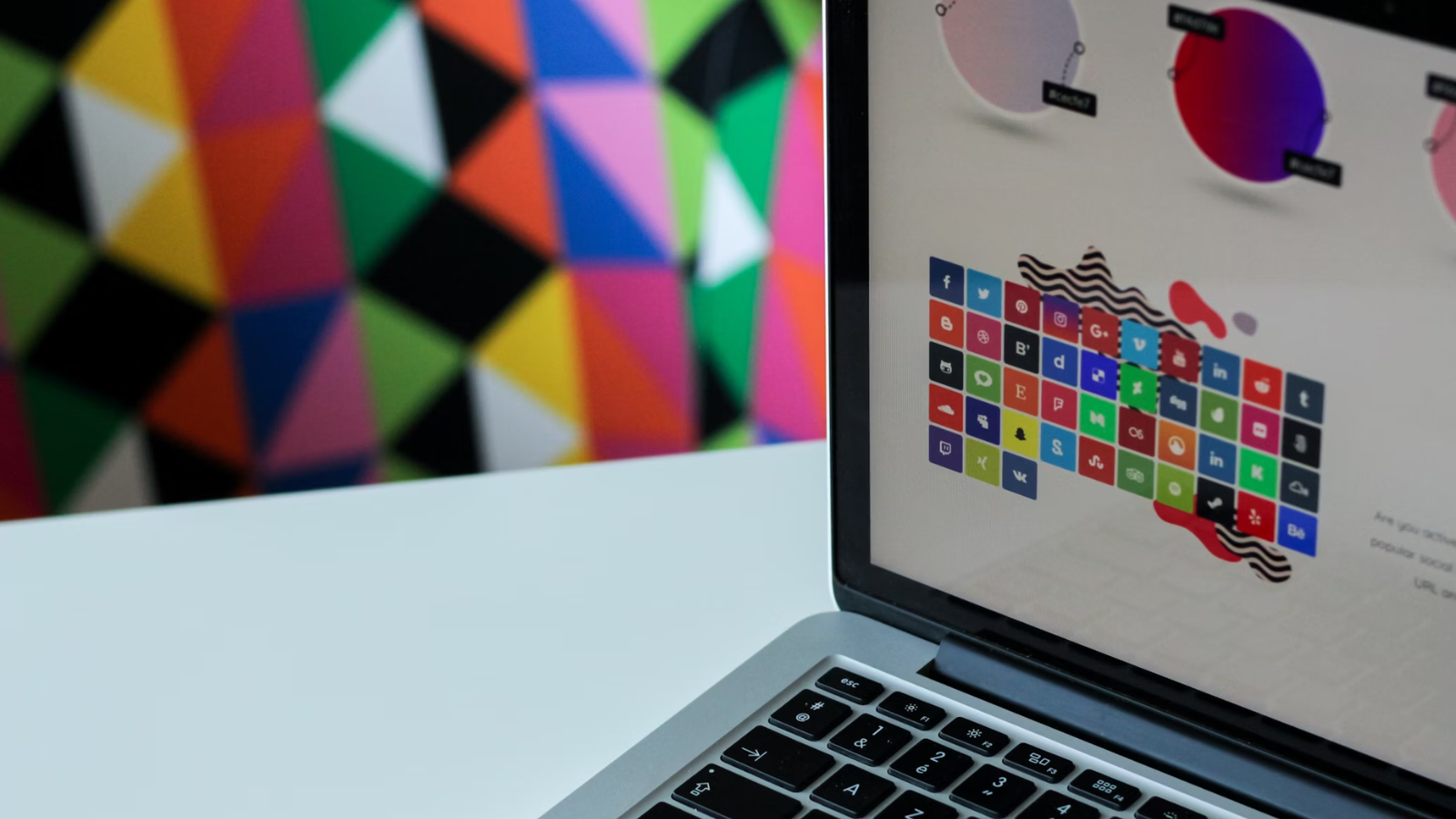 Color palette on a laptop with a colorful wall in the background