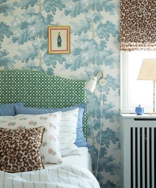 floral wallpapered bedroom with leopard print blind and a retro wall sconce