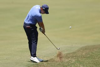 Matt Fitzpatrick hits a shot from the rough at the US Open
