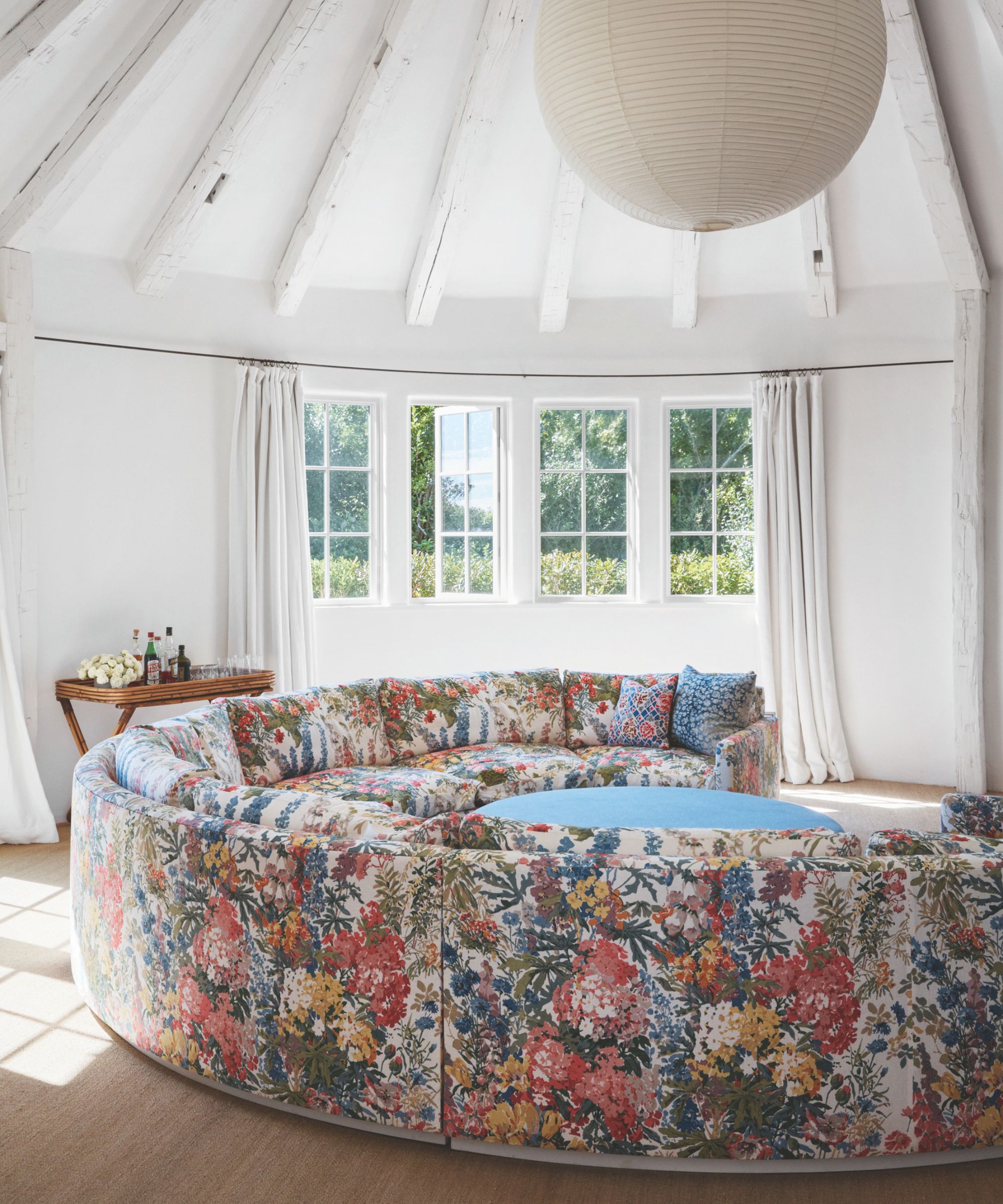 Large floral sofa in a white room