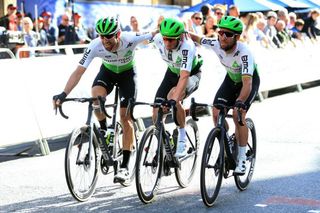Bernie Eisel (left) and Mark Cavendish (right) help Dimension Data teammate Mark Renshaw across the finish line on the final stage of the 2019 Tour of Britain – the Australian's final race as a pro