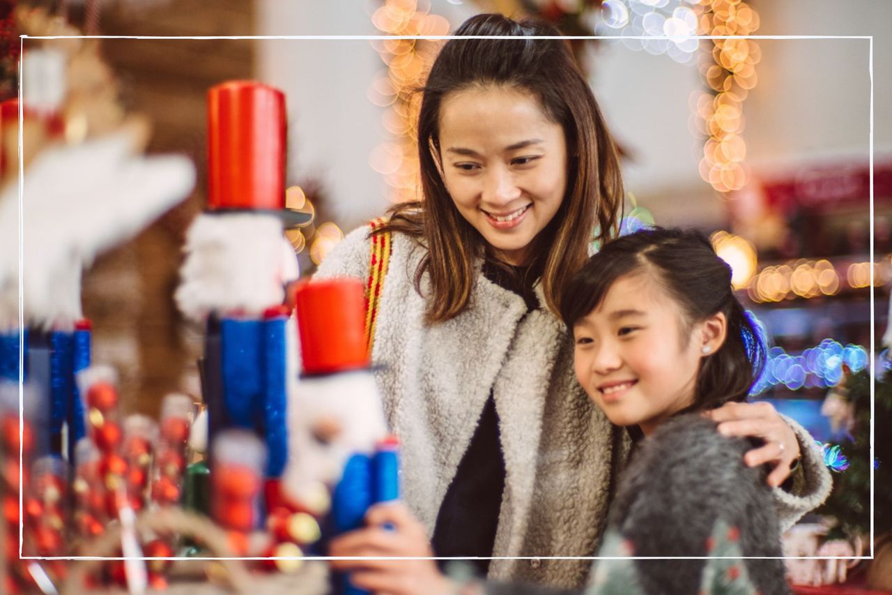 Parent and child looking at Christmas decorations