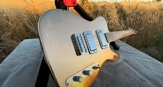 Burls Art Copper Bronze Guitar, glinting in the sunlight