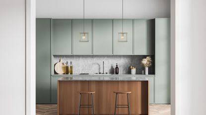 Sleek Cube Pendant Light - 8 Inch - Brass hangingin in a small kitchen with a wooden island and sage green cabinets
