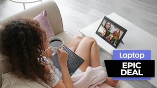 Woman sitting on a couch in front of Lenovo IdeaPad Duet tablet with detachable keyboard in lap