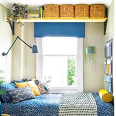 guest bedroom with white walls and shelves on wall