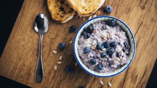 Overnight oats with blueberries next to slices of bread