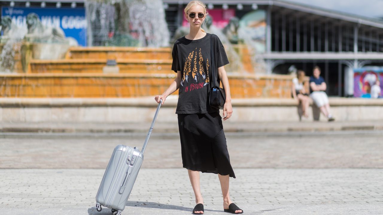 A model with a carry-on outside Sacai during Paris Fashion Week Menswear Spring/Summer 2018 Day Four on June 24, 2017 in Paris, France. (Photo by Christian Vierig/Getty Images)