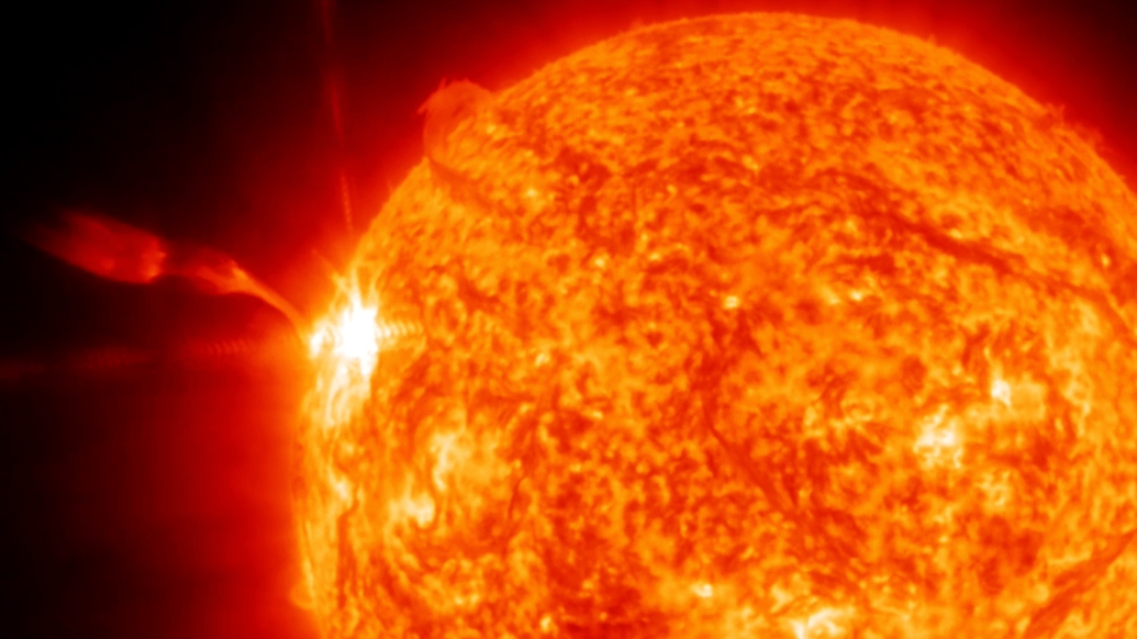 a close up view of the sun erupting with an x class solar flare over the left limb. 