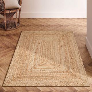 natural jute rug in a rectangle shape on a wooden floor