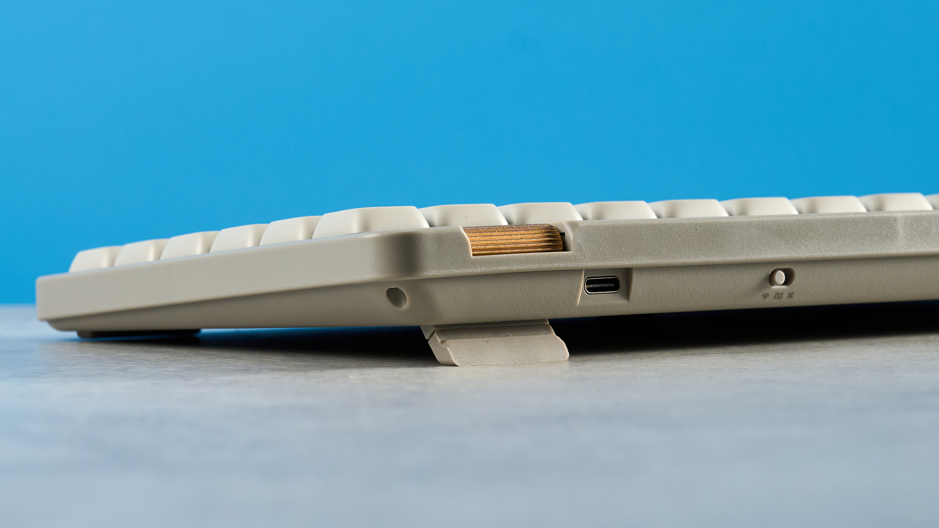 The Lofree Flow Lite84 on a stone surface against a blue background