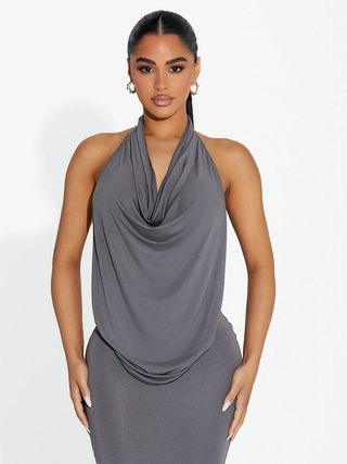 model wears gray cowl heck halter top and matching skirt