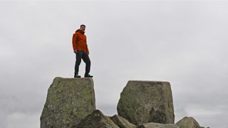 Man wearing Salewa Puez Gore-Tex Paclite Jacket while standing on Adam and Eve on Tryfan, Snowdonia
