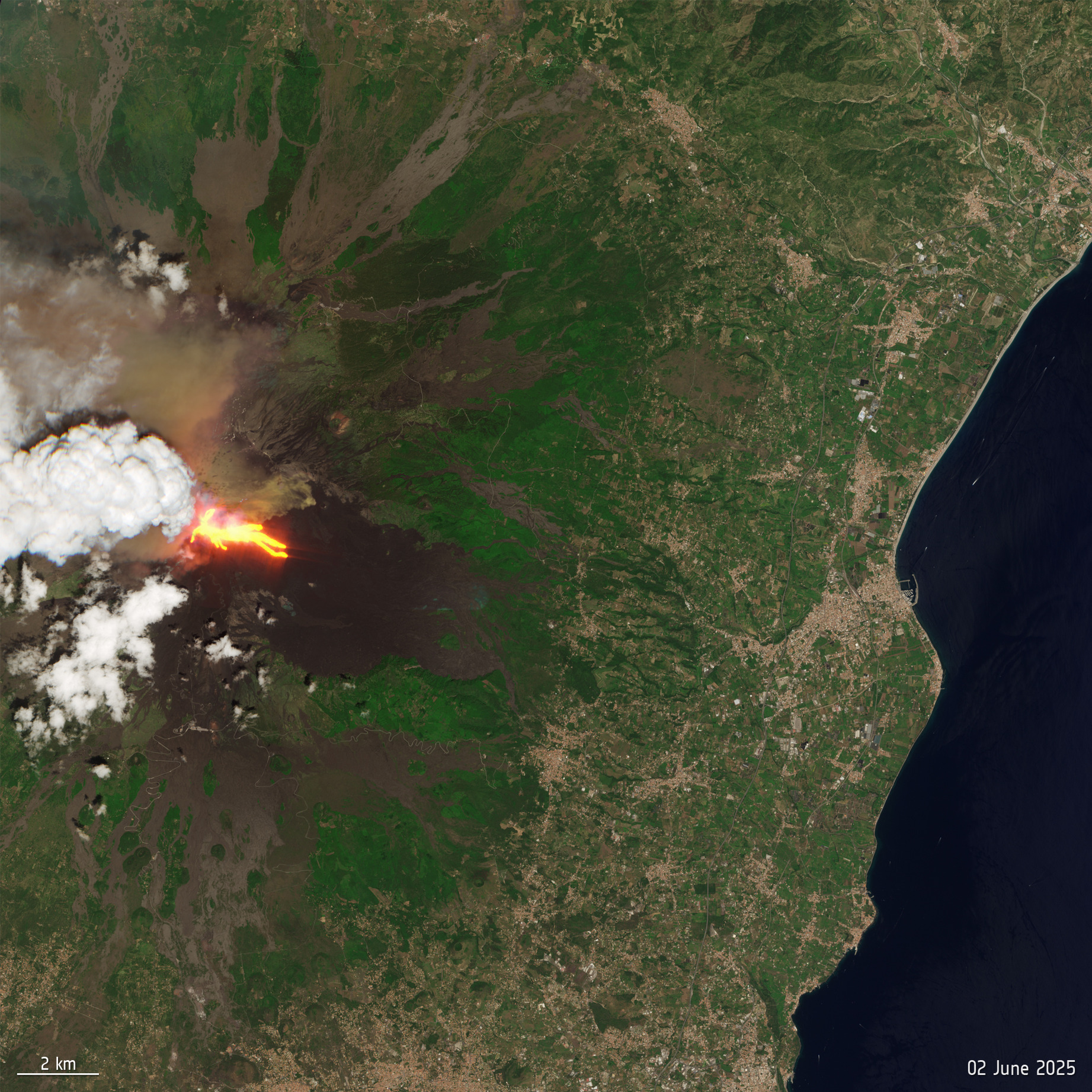 A large green shape with streaks of red and white clouds above it showing a volcano eruption of Mt. Etna