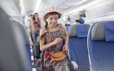 Smiling, eager girl boarding airplane