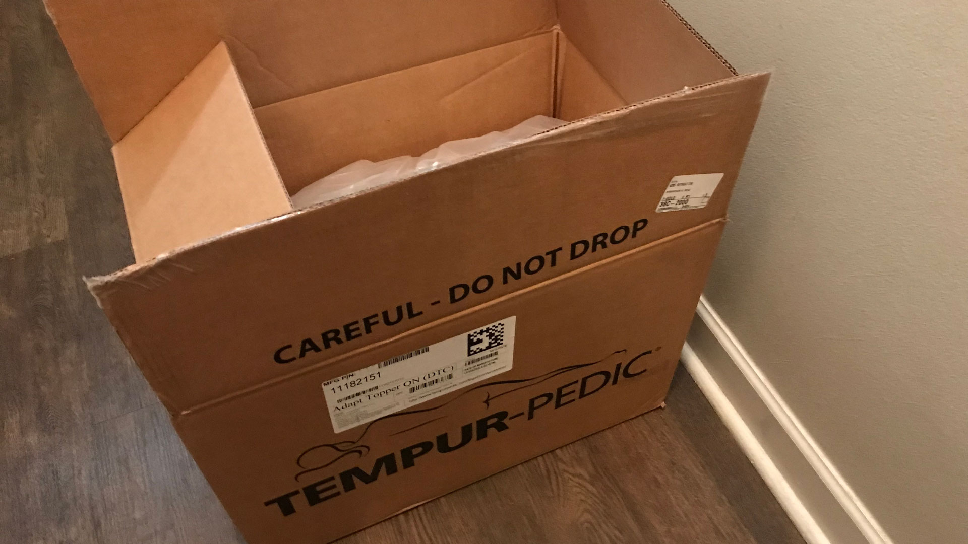 A Tempur-Pedic TEMPUR-Adapt Mattress Topper in its box