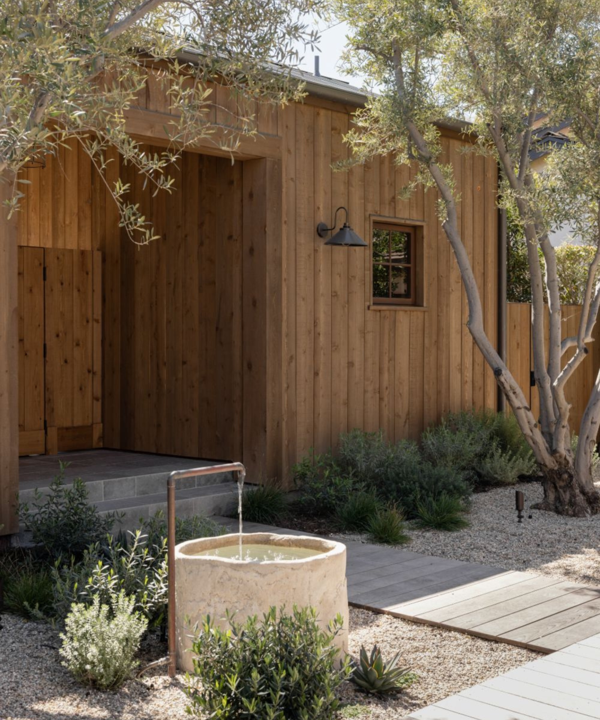 antique limestone trough used as water feature in vintage style garden