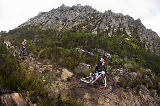 Women's category winners Ariane Kleinhans &amp; Annika Langvad of RECM portage down the historical Gamtouw Pass