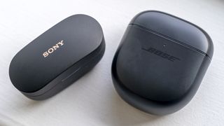 Sony WF-1000XM4 and Bose QuietComfort Earbuds II in closed cases.