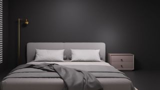 A bedroom with a dark grey wall and grey fixtures