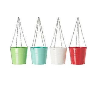 Bright colored tin herb planters hanging from chains
