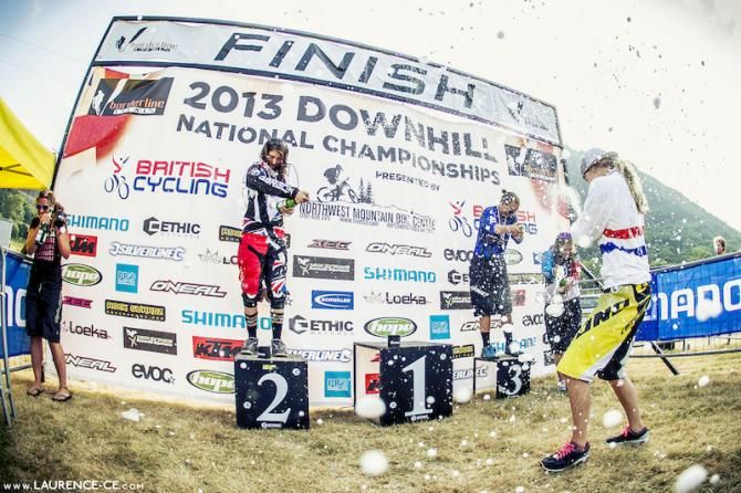 Rachel Atherton gets doused as she steps up onto the British Downhill National Championships podium