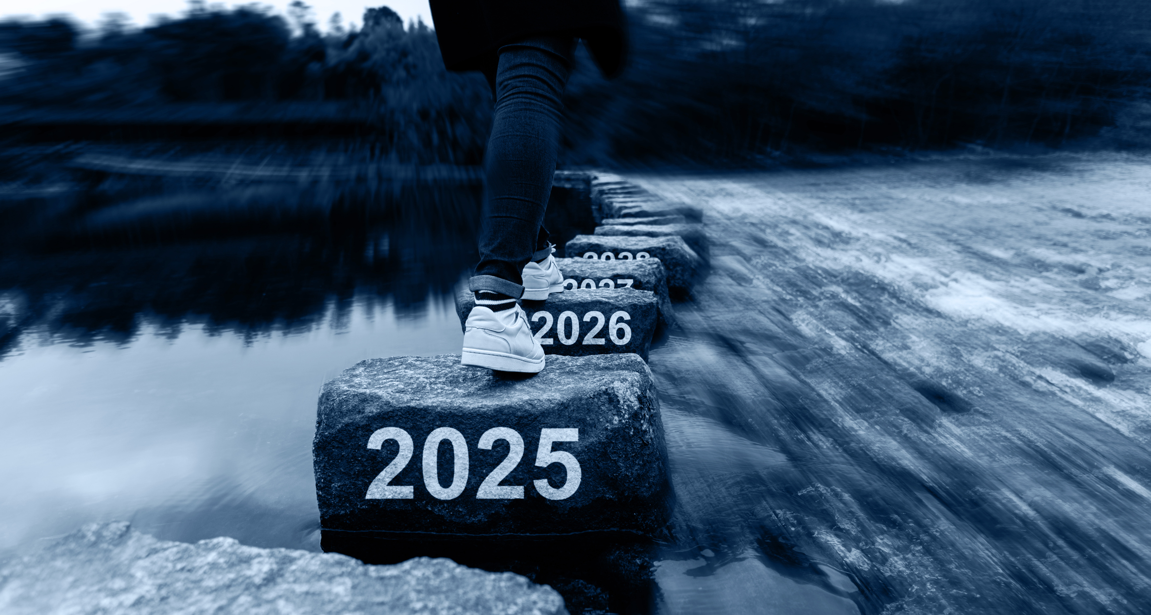Woman crossing stepping stones with new year number 2025, 2026 and 2027