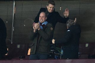 Prince William, Duke of Cambridge, (C) celebrates after Aston Villa's English striker Ollie Watkins scores their first goal during the English Premier League football match between Aston Villa and Manchester City at Villa Park in Birmingham, central England on December 1, 2021.