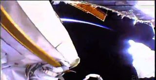 "Can you see that?" Fischer asked as he pointed out the glow of Earth's edge during a spacewalk May 23. "Wow."