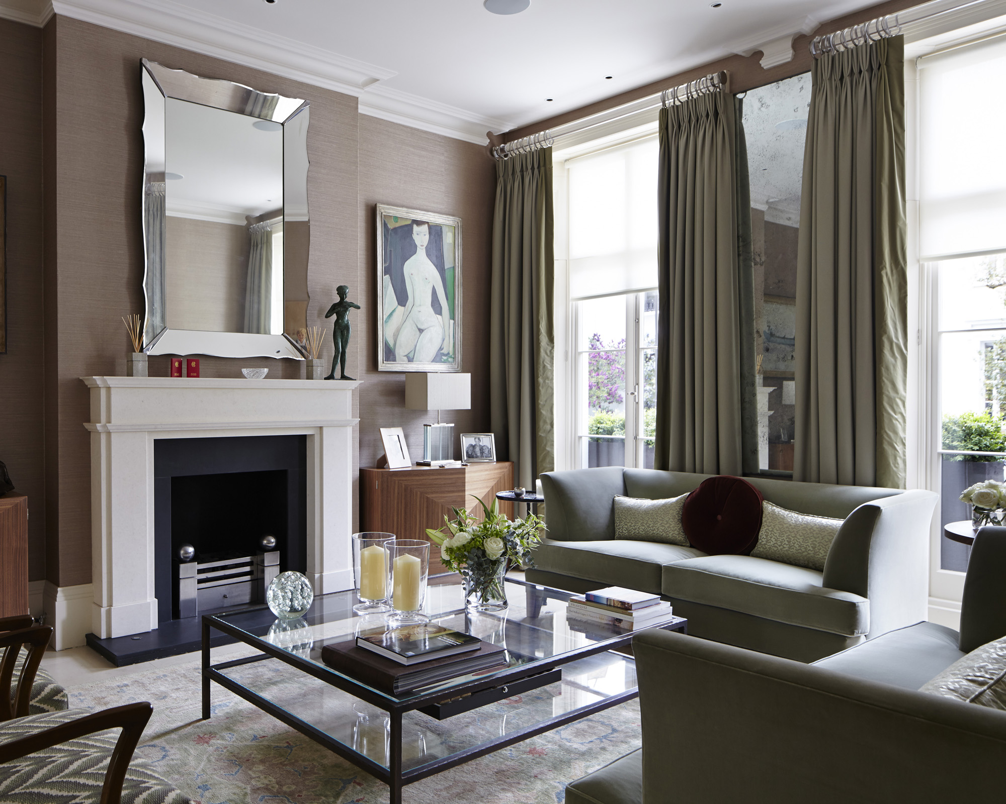 A living room mirror idea with a large bevelled mirror over the fireplace in modern room