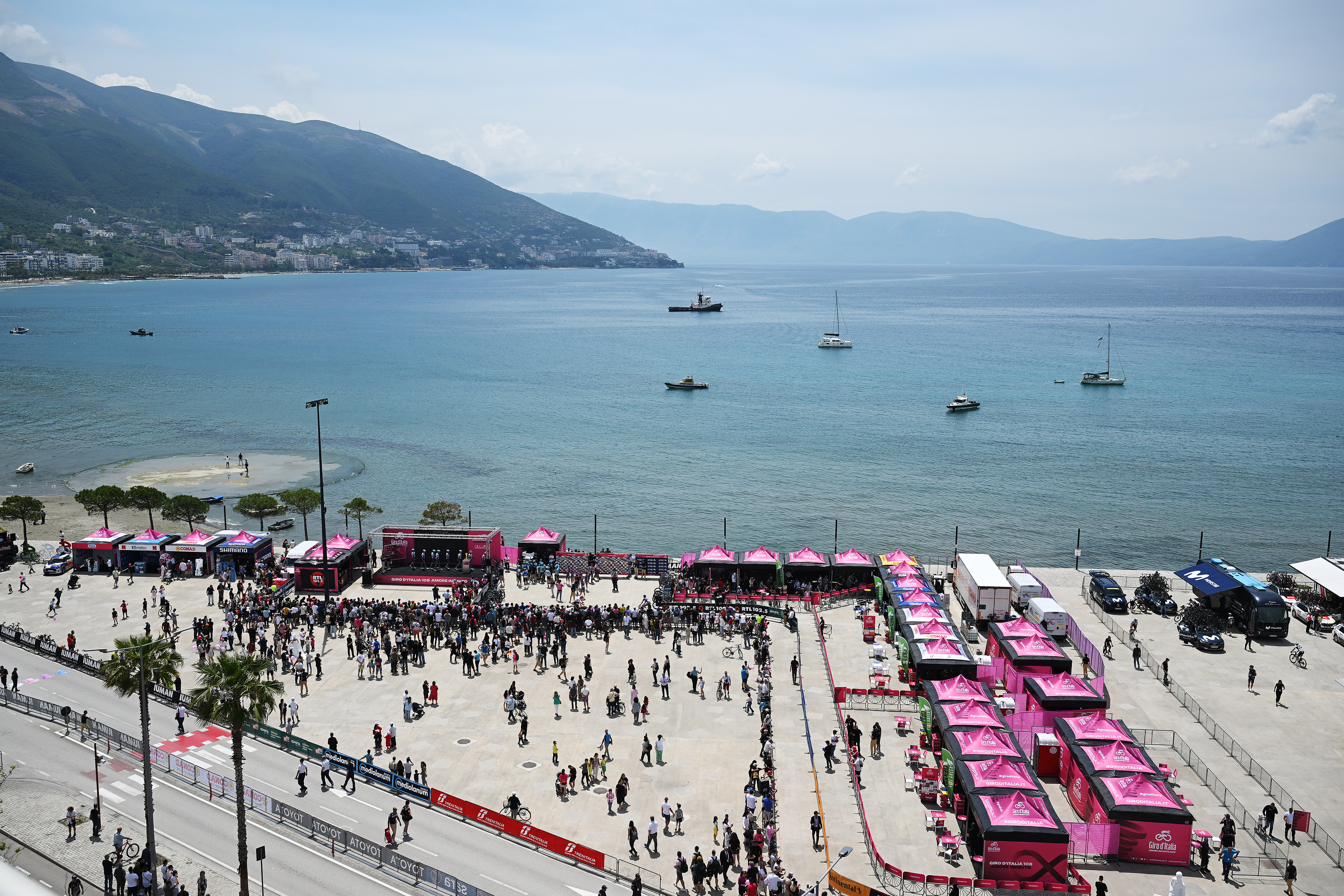 Wide shot of the Giro start village, with the Albanian coast in the background