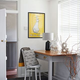 Grey home office with yellow wall art