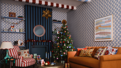 a living room with squiggle wallpaper and striped beams decorated for christmas. There are lots of vibrant colors and busy patterns across the room 
