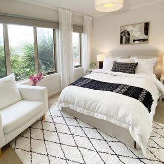 neutral bedroom with berber rug and armchair