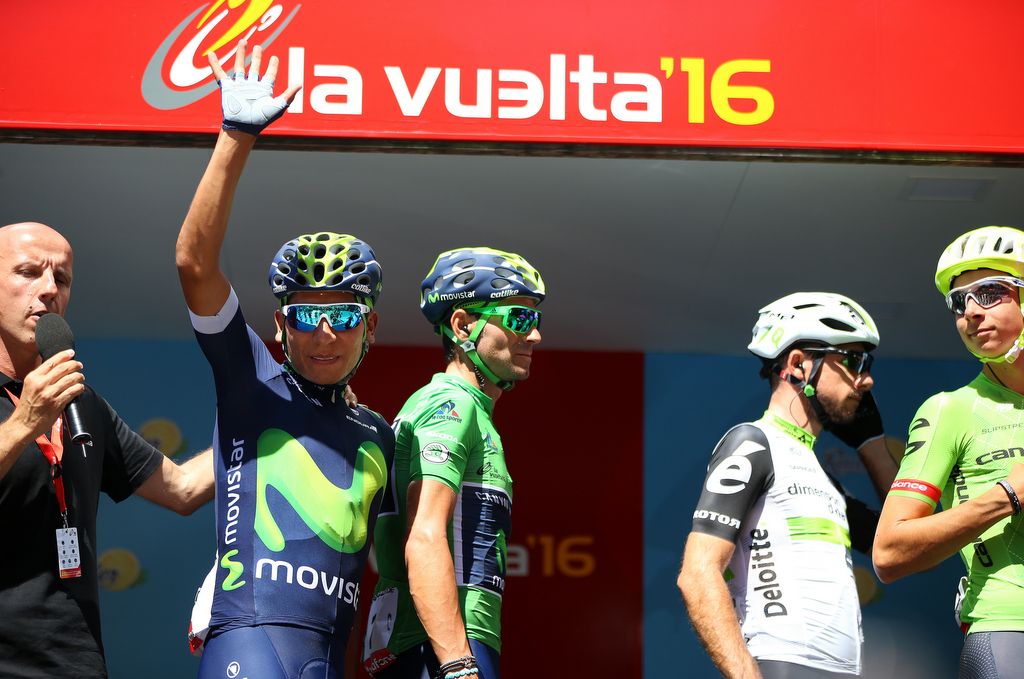 Nairo Quintana waves from the podium after signing on