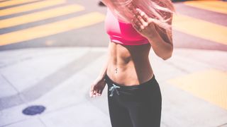 Woman with well-defined abs in sportswear