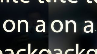 Image shows white text on black background to demonstrate contrast precision