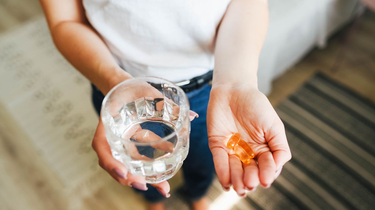 woman holding magnesium supplements