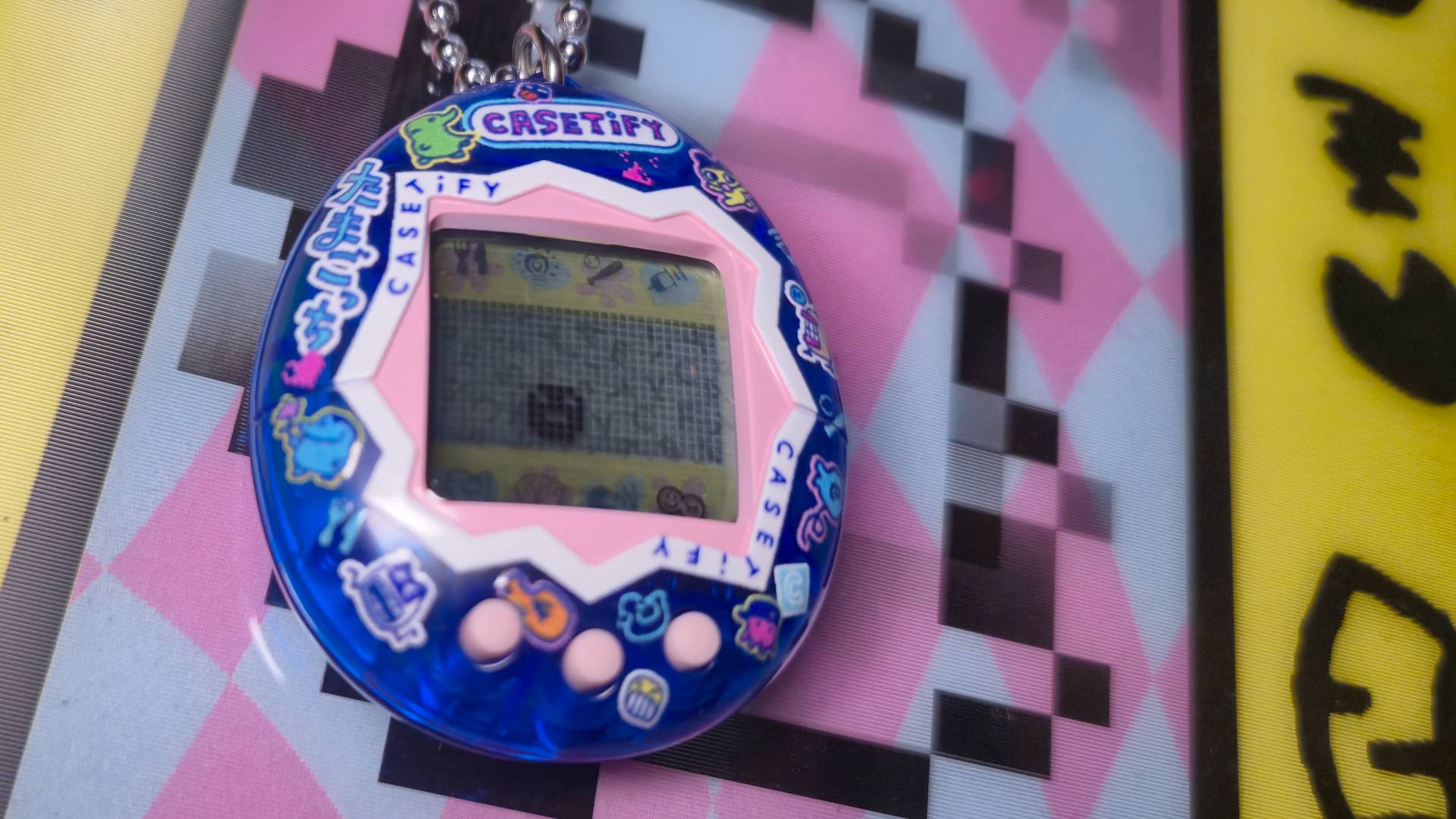 Close up of the Casetify Tamagotchi toy.