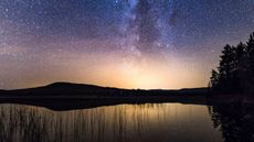The Milky Way and stars over Loch Stroan in Galloway Forest, Scotland 