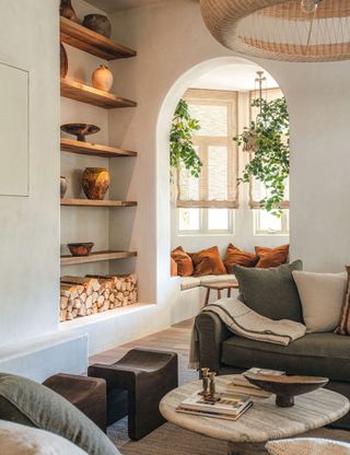 Beige living room with white walls, wood shelving and brown soft furnishings